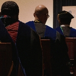 Three faculty members sitting